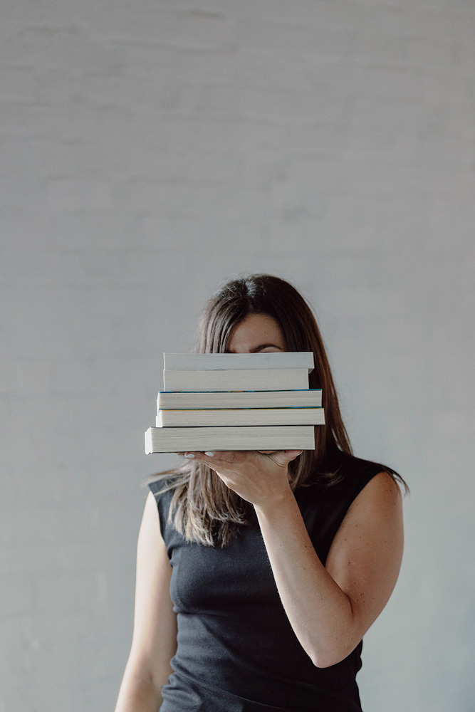 Swiftly Scripted - Wedding Invitation and Stationery Designer in Southern Ontario - Brittany Groux - Captured by Kirsten - Brittany holding books in front of her face